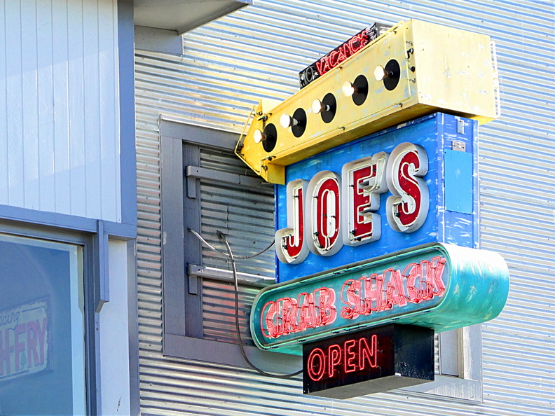 This image features a neon sign for the restaurant 'Joe's'. The sign is prominently displayed on an urban street scene, indicating the presence of a casino and a club. The design of the sign and the surrounding environment suggest a sense of nostalgia and a connection to San Francisco's cultural history. DSC08779.JPG