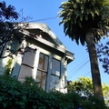 Quaint San Francisco House with Palm Trees and Blue Sky