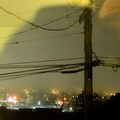 Nighttime Cityscape Amidst Rain and Mist