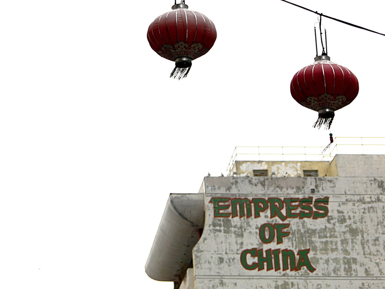 This image captures a notable landmark in San Francisco, known as 'The Empress of China'. The elevated red cages and the prominent signage are indicative of this historic building. The presence of two red baskets adds to the unique charm of the scene. DSC09035.JPG
