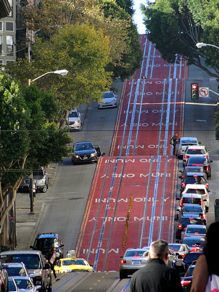 San Francisco Street with Red-Painted Hill and Traffic Signal