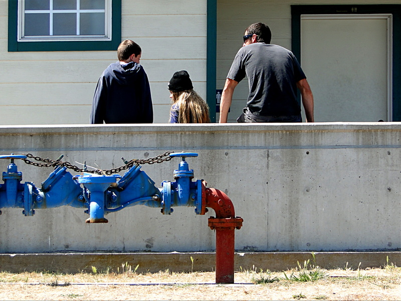 A Group of People Gathered near a Fire Hydrant