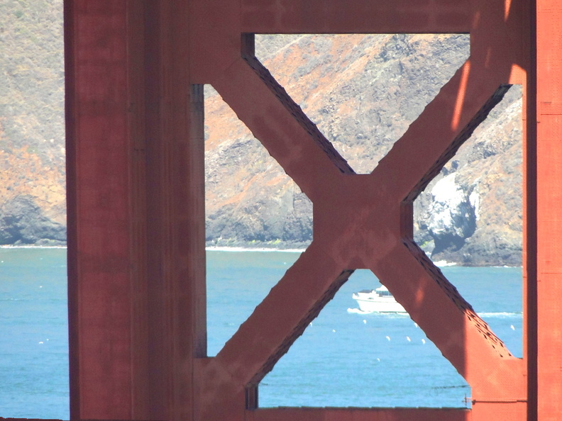 This image captures the iconic Golden Gate Bridge crosswalk, a symbol of urban architecture and transportation. The crosswalk's rustic appearance contrasts with the modern boats sailing on the water in the background, creating a picturesque scene. DSC09173.JPG