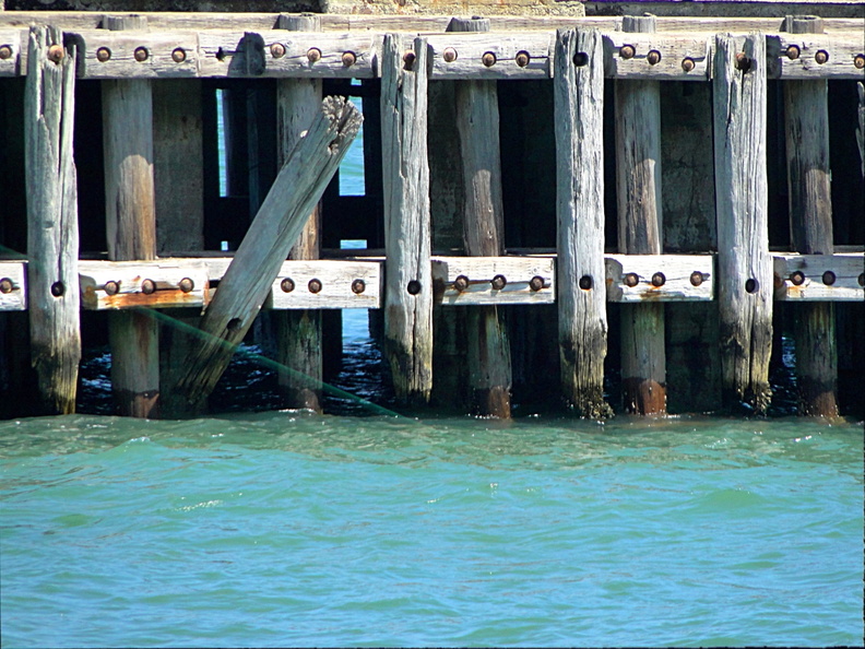 The image shows a pier in San Francisco, California, USA. The wooden structure appears to be in disrepair with noticeable damage to the decking. It's a panoramic view capturing different segments of the dock. DSC09206.JPG