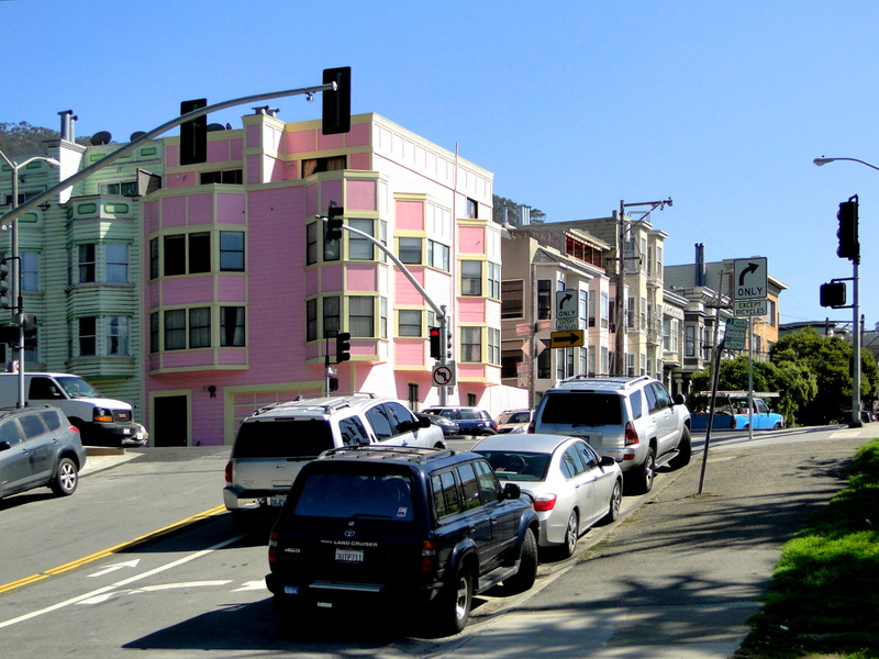 City Scene at Sunset: Vehicles on a San Francisco Street with Multi-Colored Buildings
