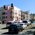 City Scene at Sunset: Vehicles on a San Francisco Street with Multi-Colored Buildings