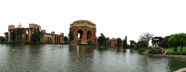 This image captures a tranquil scene featuring a picturesque lake, possibly San Francisco Bay, surrounded by lush greenery. In the foreground, there is a large body of water, likely a lake or river. On the opposite shore, there's a classical architectural structure that resembles the Roman Baths in Pompeii, adding an element of historical significance to the landscape. The image also contains a glimpse of a person on the far right edge, suggesting human activity and scale in the area. This peaceful setting offers a contrast between natural beauty and architectural grandeur. DSC09834.JPG