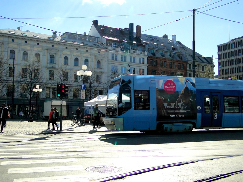 Vibrant City Life: A Blue Trolley on the Move in Oslo, Norway