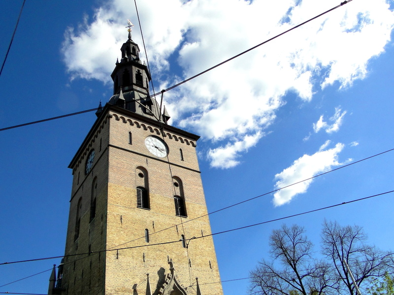 Stone Clock Tower Standing in an Urban Setting