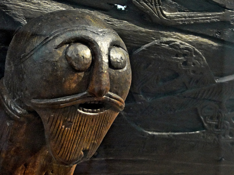Viking-Era Wooden Figure with Facial Hair and Serpent Designs