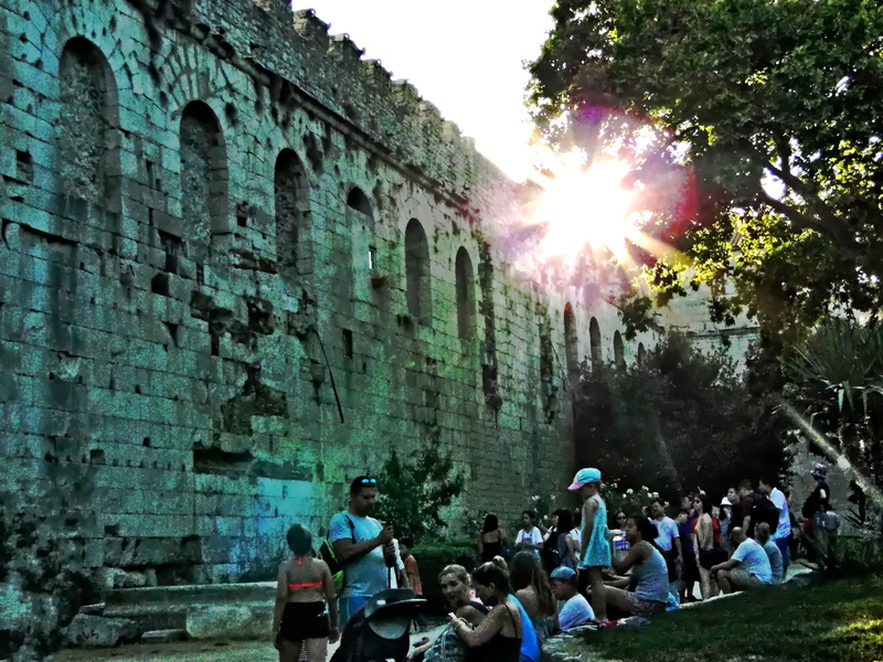 Gathering at the Foot of a Historic Stone Structure in Split, Croatia