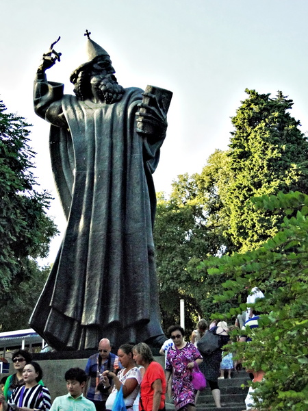 Historic Sculpture of a Religious Figure in City Park