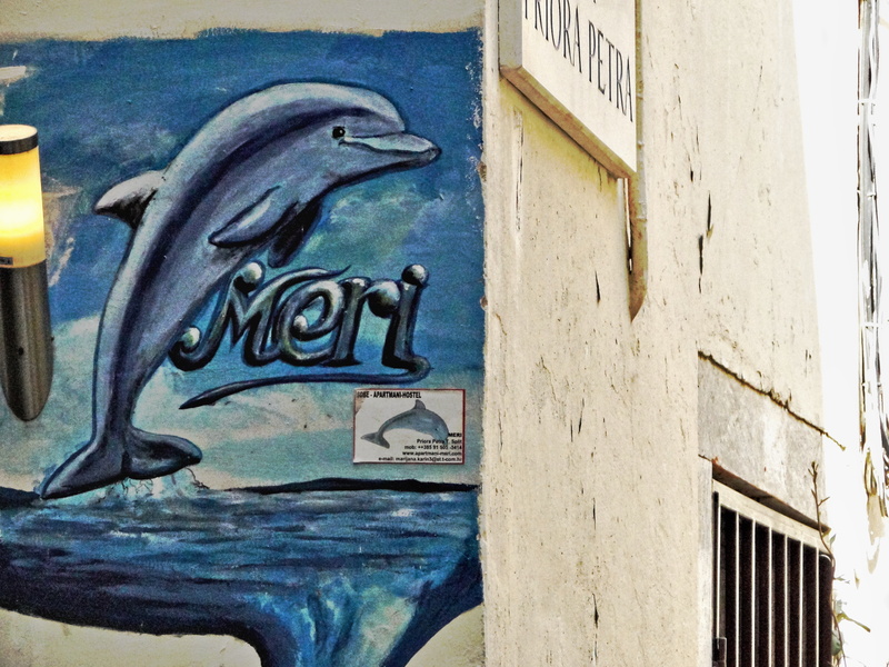 Mural of a Dolphin with the Word 'Mermaid' on a Wall
