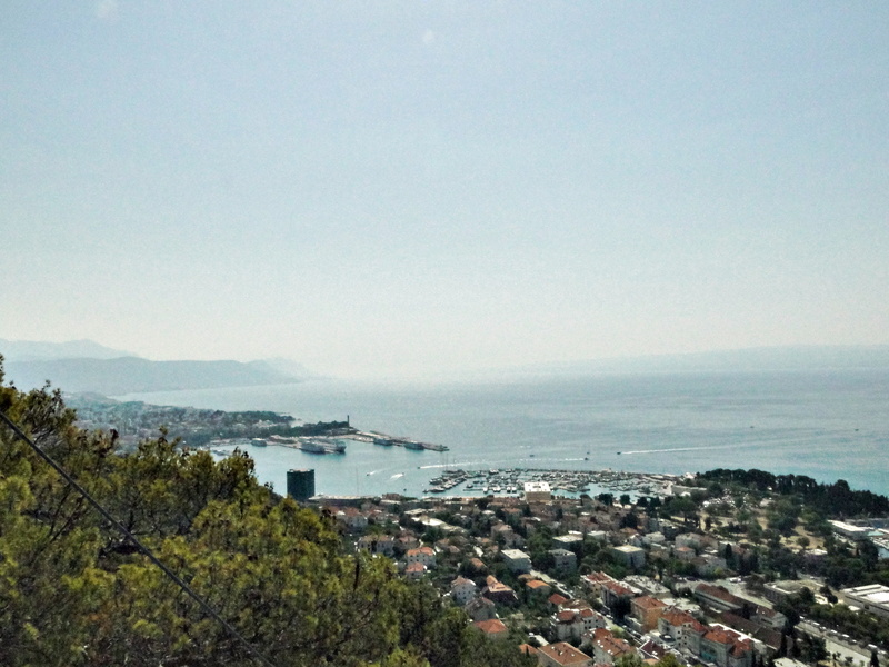 Serene Coastal Town at Dusk with Clear Sky and Mountains