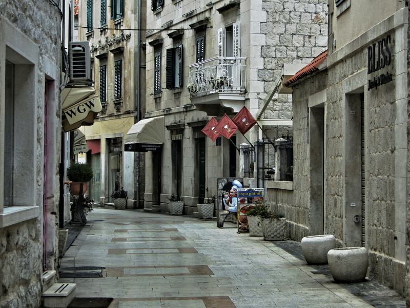 Narrow Street in Split, Croatia: A Quaint Alleyway with Local Shops and Vacant Spaces
