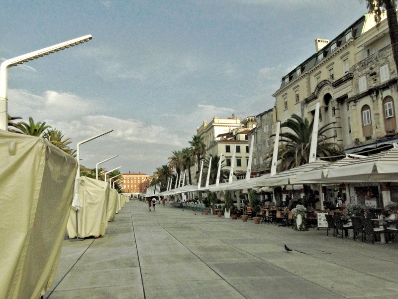 Vibrant City Street with Market Stalls and Tourist Attraction