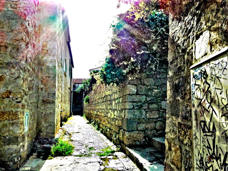 Narrow Stone Alleyway with Sunlight