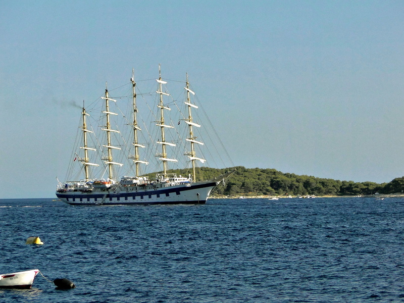 Grand Sailing Ship Cruising Near Island Shoreline
