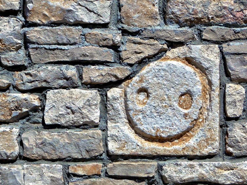 Weathered Sign on Stone Wall in Supetar, Croatia