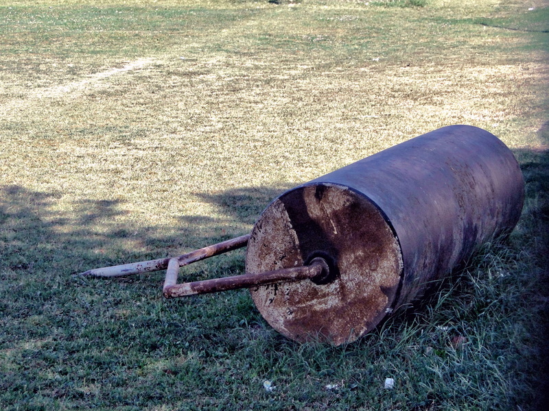 Abandoned Rusty Barrel on a Grass Field