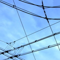 Overhead Power Grid against a Blue Sky Backdrop