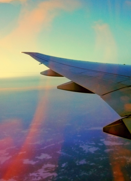 The image captures a serene moment in the sky, where an airplane is soaring during sunset. The sky is adorned with vibrant hues of orange and pink, creating a beautiful backdrop for the airplane's journey. DSC07199.JPG