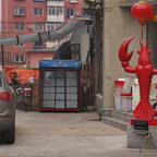 Vibrant Shenyang Street Scene with a Crab Statue and Shop