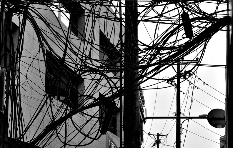 An intricate view of Shenyang's electrical grid, where power lines crisscross against the backdrop of a Chinese cityscape. DSC07276.JPG