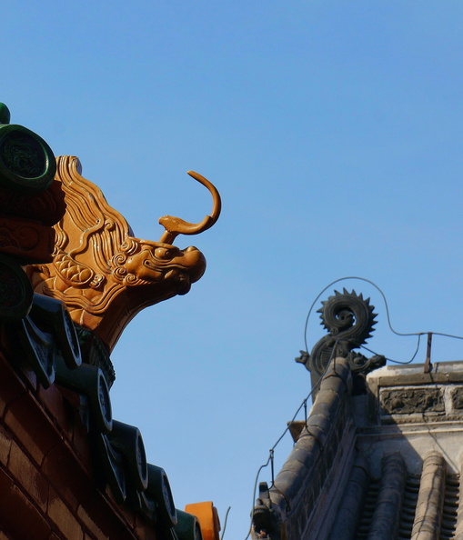 This image showcases a traditional Chinese architectural detail, specifically a dragon head on the facade of an old building. The dragon head is a common motif in East Asian architecture and symbolizes strength, power, and good luck. DSC07703.JPG