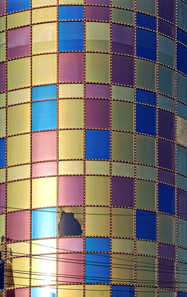 A tall, multi-colored brick tower standing against a gray sky. The tower features a mix of warm and cool colors on its exterior, creating a striking contrast with the clear day. DSC07849.JPG