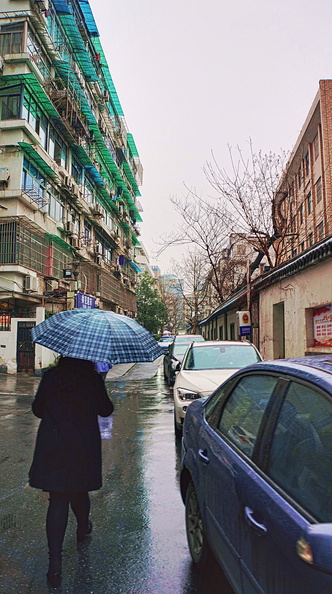 A Rainy Day in Hangzhou, China: A Moment of Solitude on a City Street