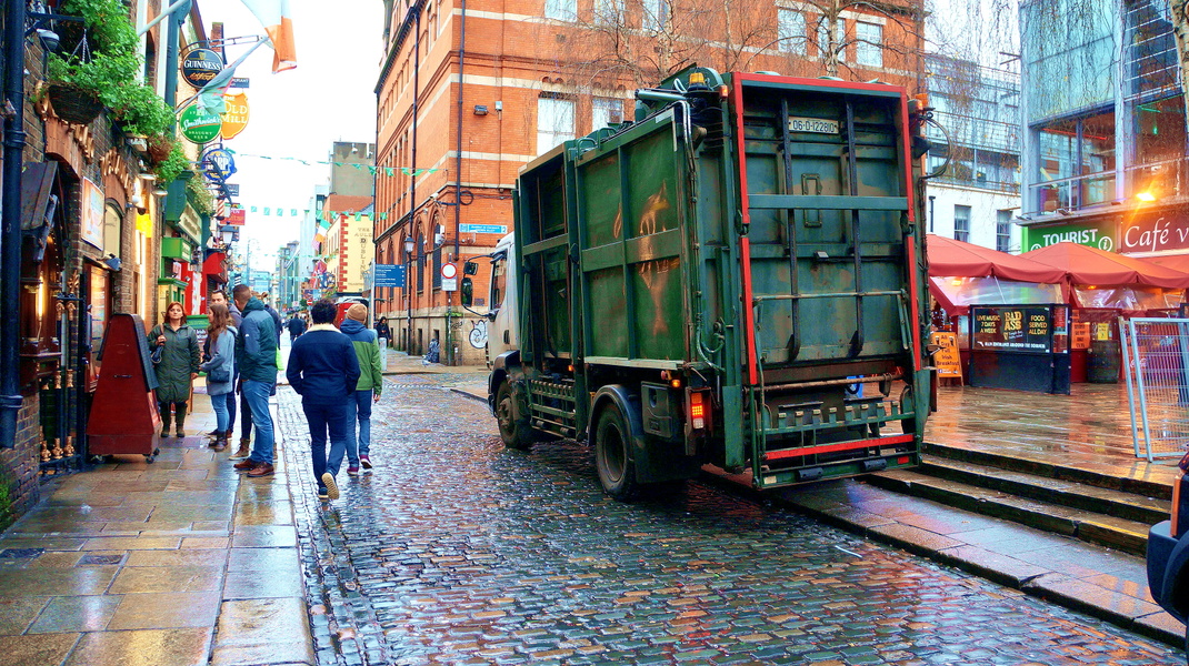 A Rainy Day in the City: Vehicles and Pedestrians Braving the Downpour