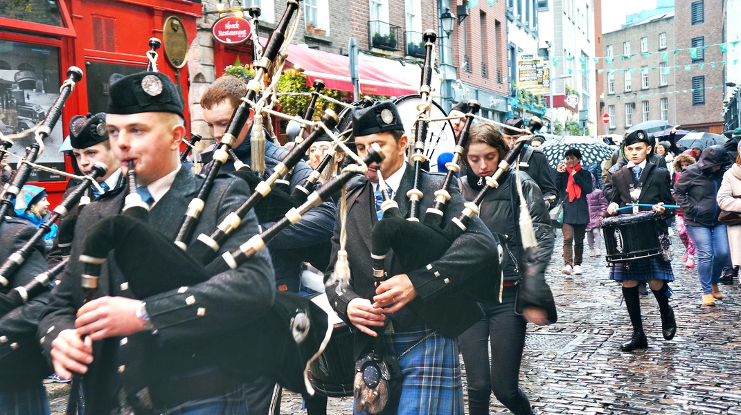 Parade of Scottish Bagpipers in a European City
