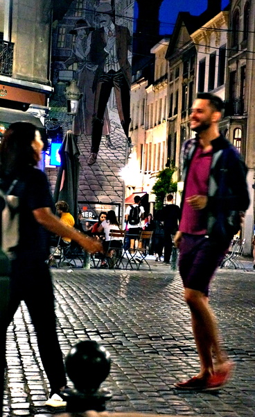 Couple Strolling on a Cobblestone Street at Night
