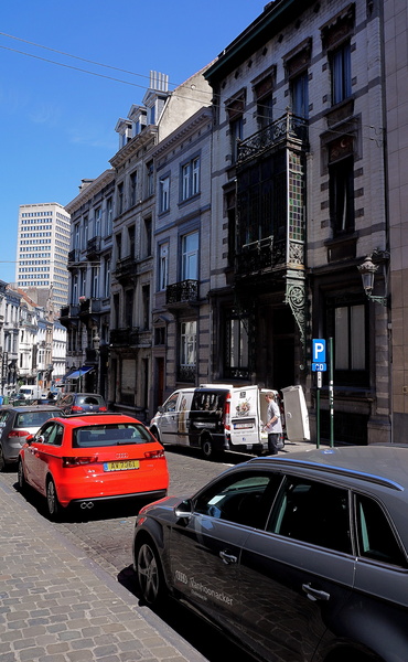 A Sunny Day in Brussels, Belgium - Urban Street Scene with Parked Cars and Buildings