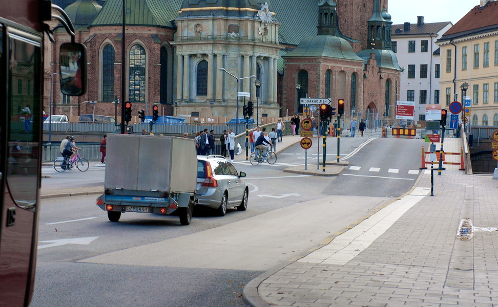 A Scenic View of Stockholm, Sweden - A City Intersection with Pedestrian Crossing and Church in the Background
