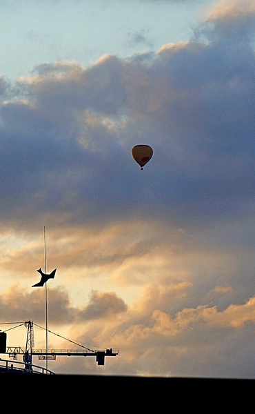 Stockholm's Nighttime Skyline with a Hot Air Balloon in Flight