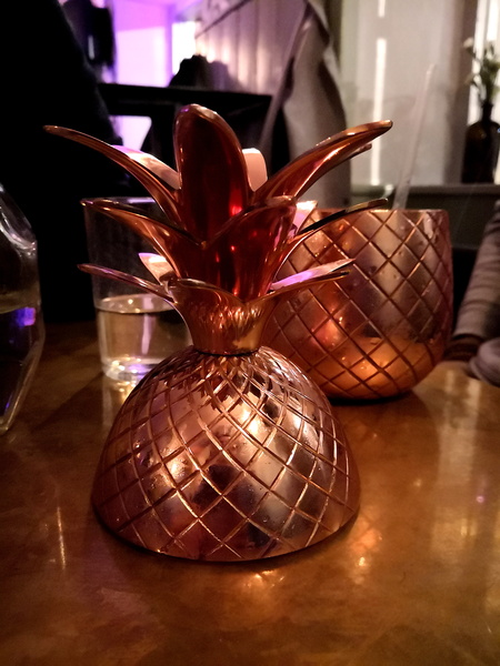 Vintage-style pineapple candle holders on a table