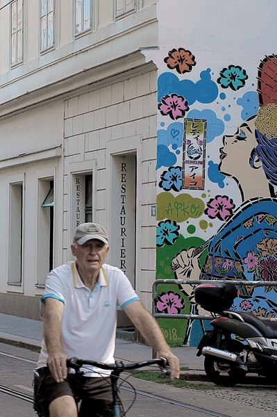 A man enjoying a bike ride on a colorful street