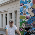 A man enjoying a bike ride on a colorful street