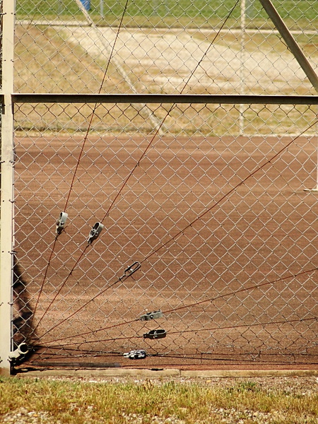 Abandoned Soccer Goal on a Fence