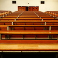 Vacant School Hallway with Wooden Desks and Chairs