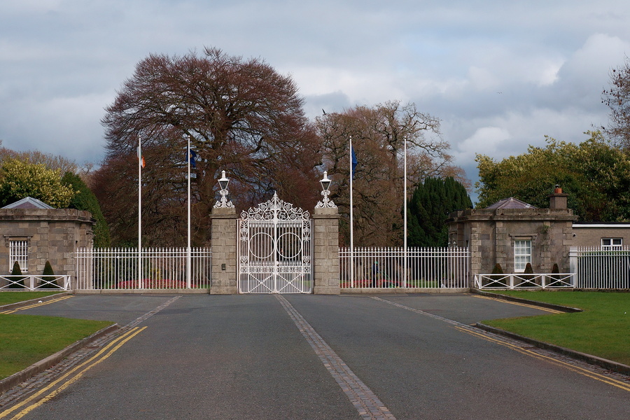 Official Entrance of an Irish Government Building, with a historical design and a formal park setting.