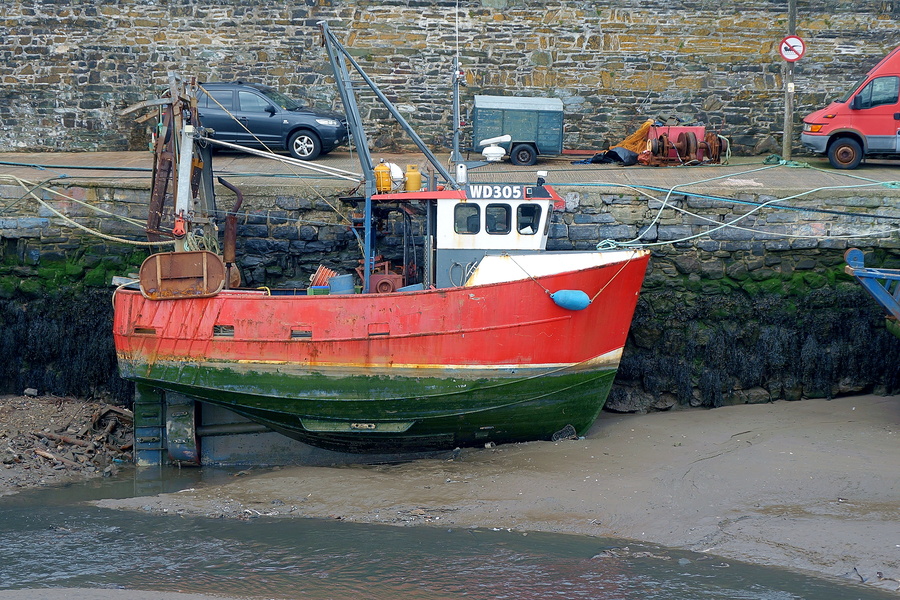 Aquatic Relic: Abandoned Fishing Boat on a Rusty Pier