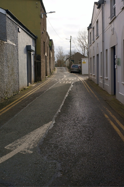 Rural Street with Wet Road and Buildings