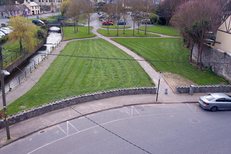 A serene rural park with a winding waterway