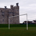 A Serene Scene: A Sports Field Near a Castle-like Structure