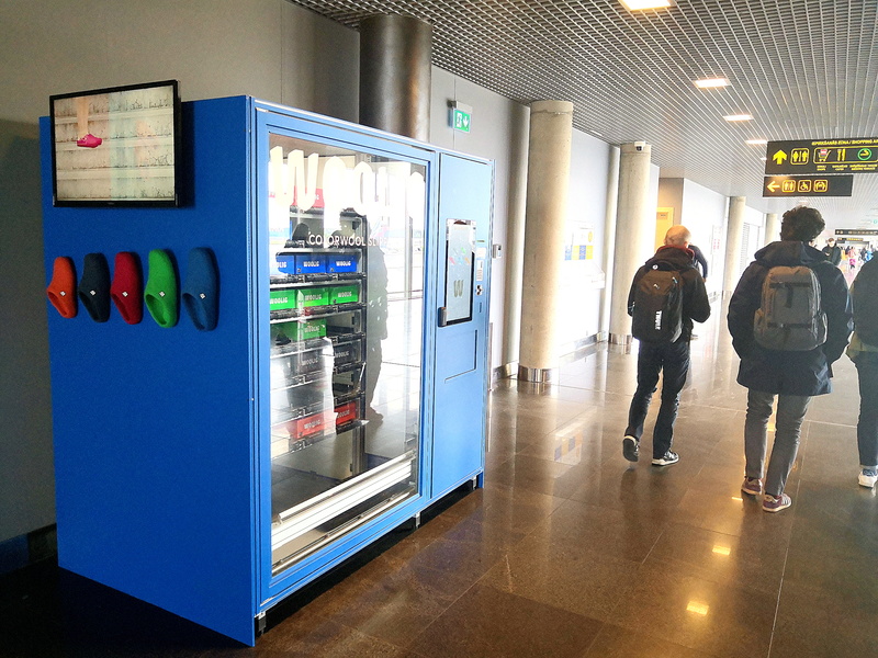A Blue Vending Machine in an Airport Waiting Area