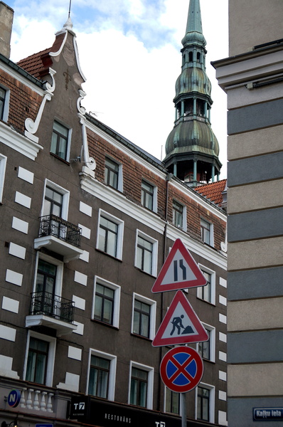 Historic Riga Street with Church Tower and Signage