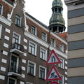 Historic Riga Street with Church Tower and Signage